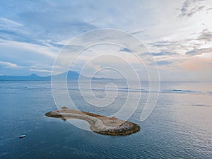 Sanur beach on the island of Bali in Indonesia. Traditional Balinese gazebos on the island. An Iconic Landmark of Sanur