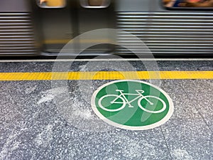 Adhesive plate on the ground indicating bicycle access area in brazilian subway photo