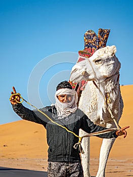 Tuareg man posing with his dromedary