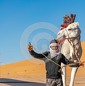 Portrait of a Berber man and his dromedary