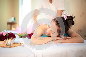 Sap Massage. Masseur doing massage with treatment sugar scrub on Asian woman body in the Thai spa lifestyle, so relax and luxury