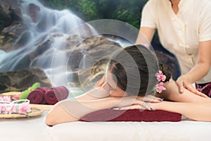 Sap Massage in waterfall nature. Masseur doing massage with treatment sugar scrub on Asian woman body in the Thai spa lifestyle,