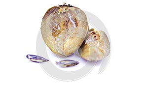 Sapota fruit cut into pieces and seeds in white background