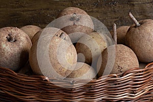 Sapotis  fruit  exposed  in basket in rustic wood background