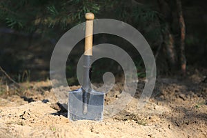 sapper shovel in sand photo