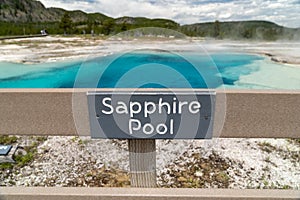 Sapphire Pool, located in Biscuit Basin, in Yellowstone National Park is a geothermal hot spring feature. Sign