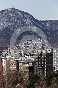 Sapporo cityscape with buildings and mountain in the background in Hokkaido, Japan