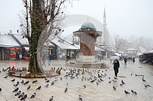 Sarajevo, Bascarsija, city centre at winter day. Old town quarter and Sebilj fountain. Tourist destination and famous landmark. Th