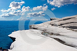 Sarakiniko beach at Milos island, Cyclades Greece. White rock formations, cliffs and caves over blue sea