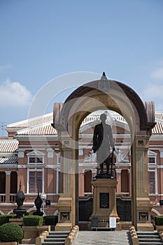 Saranrom Palace architecture in orange with a monument in Bangkok