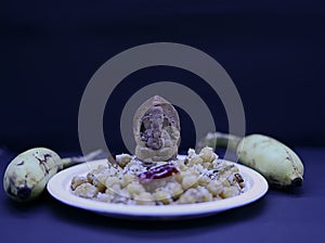 Saraswathi Pooja and Ayudha Pooja Celebrations - Cooked chickpeas, banana on black background.