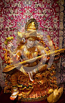 Saraswati Hindu God playing sittar / vina photo