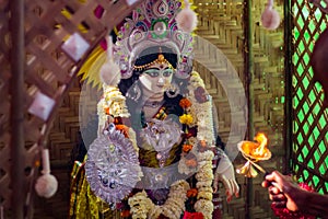 Saraswati puja festival rituals being performed by priest. Idol of Hindu goddess Sarasvati being worshipped during Sarasvati puja 
