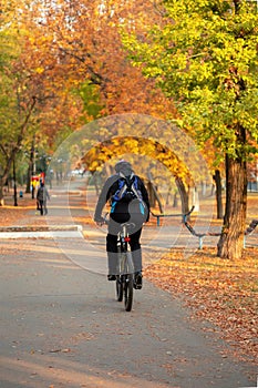 Saratov, Russia - 10/04/2020: Active healthy lifestyle, leisure sports, cyclist man rides a bicycle along the path in the park in
