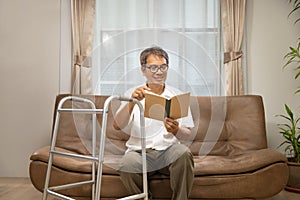Sarcopenia older man is reading a book for relax at nursinghome . Sarcopenia is a degenerative disease of the muscle usually photo