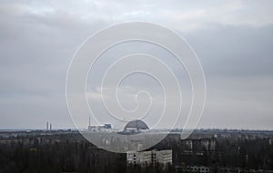 Sarcophagus (new shelter) of reactor 4 nuclear power plant and Pripyat ghost town at Chernobyl Exclusion Zone