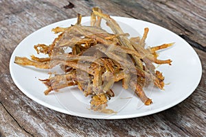 Sardines being prepared with sea salt