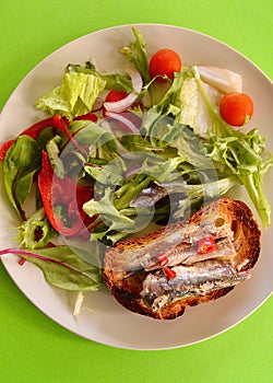 Sardines on toast with chili and salad