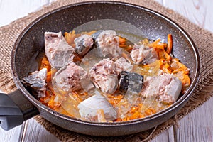 Sardines with vegetables in a pan