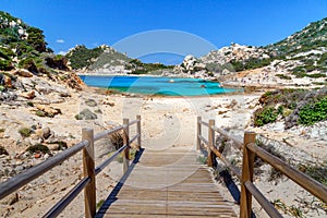 Sardinia, holidays, beautiful beaches of the archipelago of La Maddalena, a wooden bridge leading to the beach.