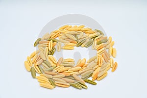 Sardinian gnocchetti pasta, also known as malloreddus or macarrones de punzu, isolated on a white background photo
