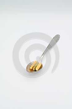 Sardinian gnocchetti pasta, also known as malloreddus or macarrones de punzu, on a spoon, isolated on a white background photo