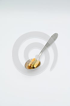 Sardinian gnocchetti pasta, also known as malloreddus or macarrones de punzu, on a spoon, isolated on a white background photo