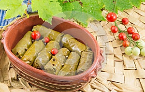 Sarma rolls in a traditional plate and cherry tomato