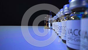 SARS-CoV-2 drug vaccine vials standing in a row on table close up