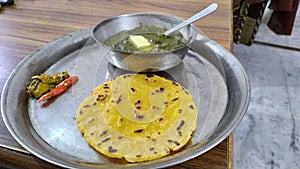 Sarson saag with makki chapati with lots of butter , pickle photo