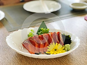 Sashimi and sashimi on plate with chopsticks.