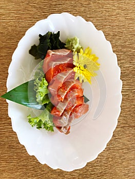 Sashimi and sashimi on plate with chopsticks.
