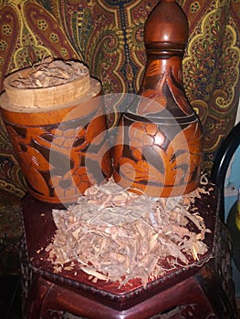 Sassafras root bark in an antique wine decanter.