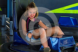 Sassy Young Girl On a Bumper Car Ride Looking at the Camera in a photo
