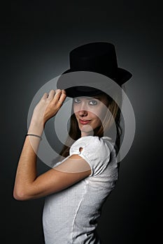 Sassy teenage girl with black top hat and big eyes photo