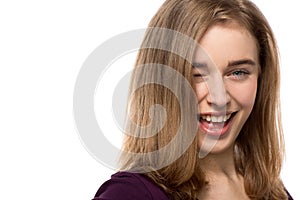 Sassy young woman giving a mischievous wink photo