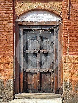 Saswad, India, old vintage wooden door on retro wall