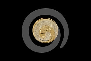 A satang coin from Thailand on a black background