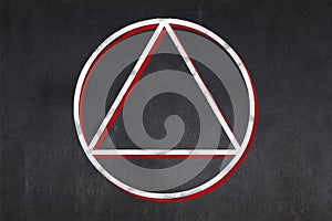 Satanist triangle within a circle symbol drawn on a blackboard