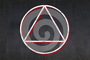Satanist triangle within a circle symbol drawn on a blackboard photo