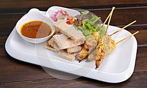 Satay Chicken , Sate Ayam with Peanut Sauce and bread , Asian sk