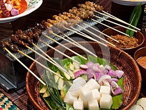 Satay and condiments photo