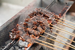 sate ayam traditional culinary of chiken satay skewer being grilled using charcoal