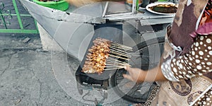 Sate Madura Satay Madura is a chicken satay served with a lontong sprinkled with peanut sauce and sliced onions. This is a typic