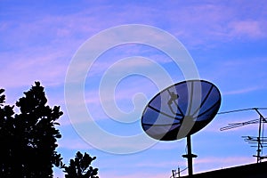 Satelite dish in twilight sky