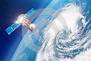 Satellite above the Earth makes measurements of the weather parameters. Research, probing, monitoring of tracking in a tropical st