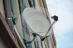 satellite antena on home facade at the window