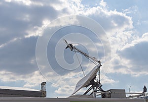 Satellite antenna on the wall with blue sky