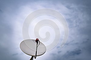 Satellite dish antenna isolated on blue sky background