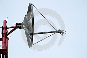 Satellite dish antenna on the mast close up